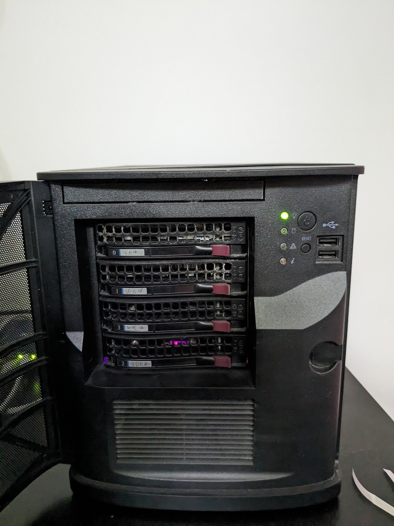 Four hard drive bays in a black chassis